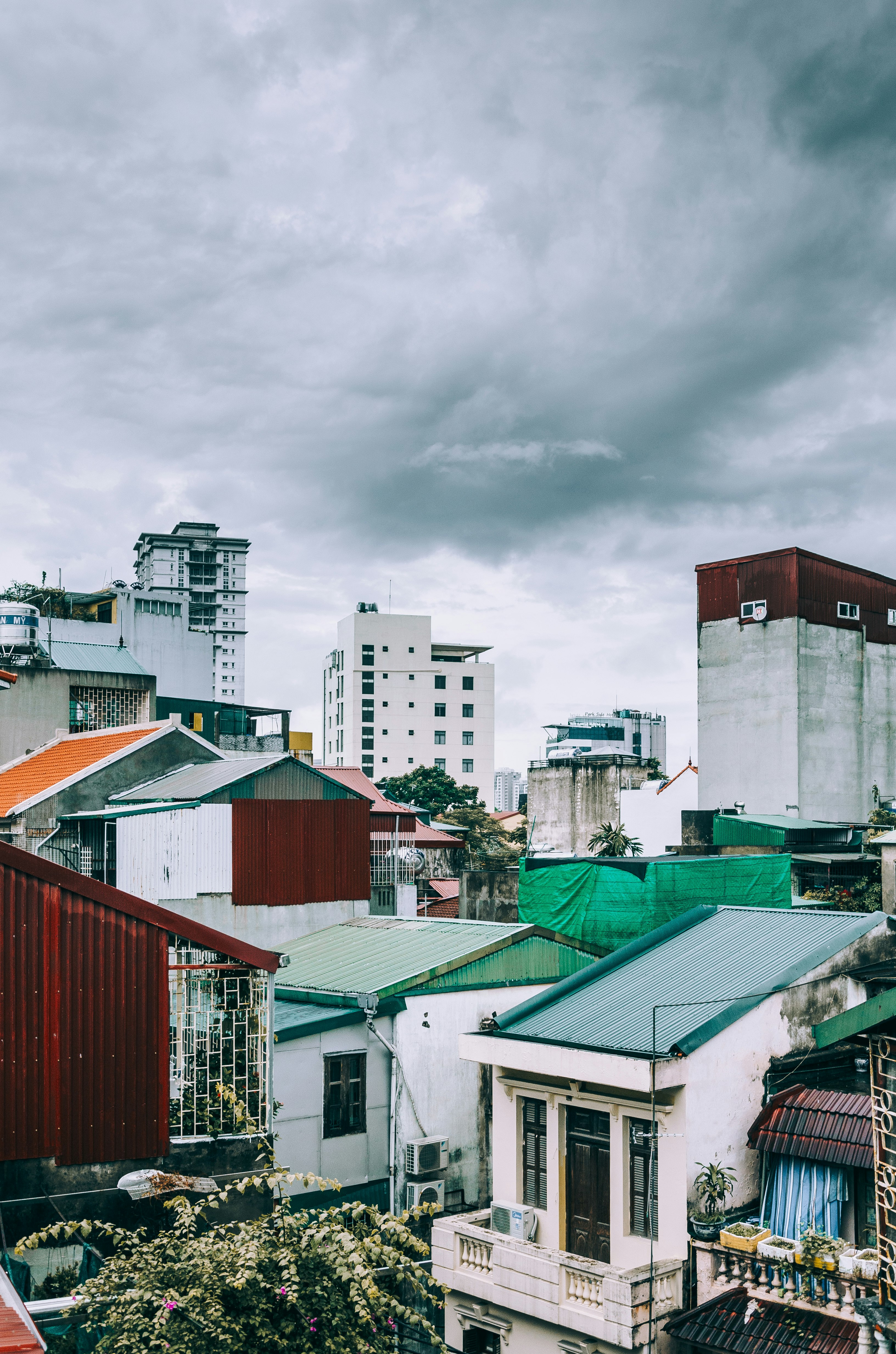 white and gray concrete mid-rise buildings under gray clouds